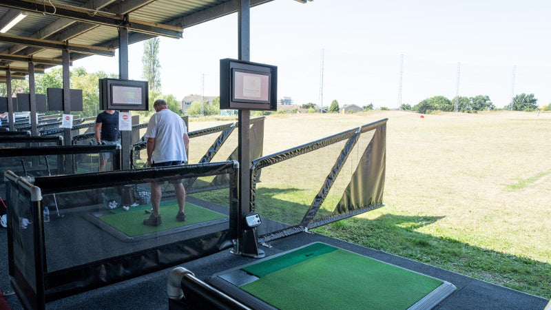 Golfers practising at The Golf Venue driving range