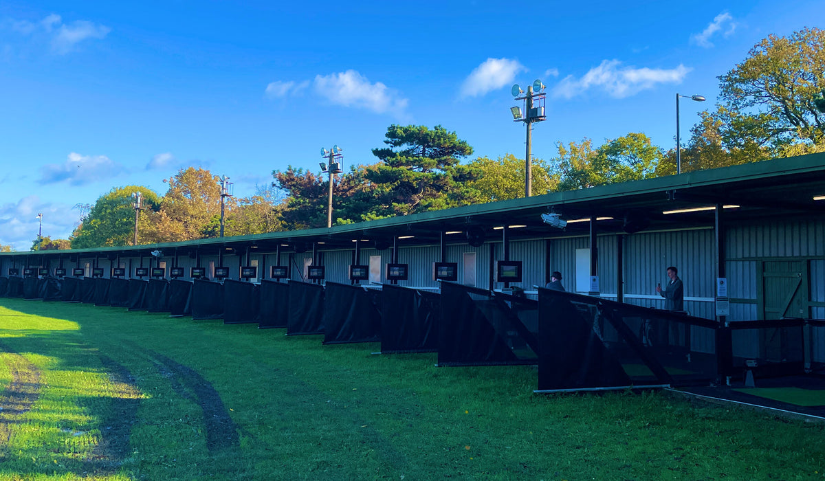 Golf lesson bays at The Golf Venue driving range